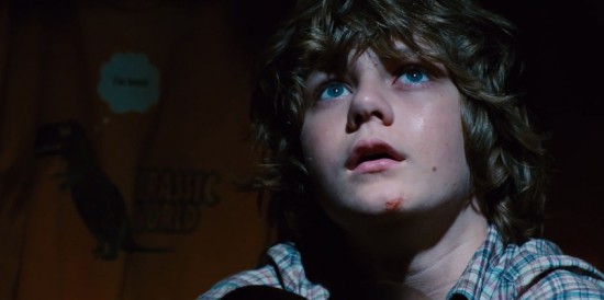 Gray (Ty Simpkins) hiding out in one of the Jurassic World gift shops.